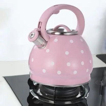 Vintage rose teapot sitting on gas stove burner