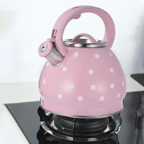 Vintage rose teapot sitting on gas stove burner