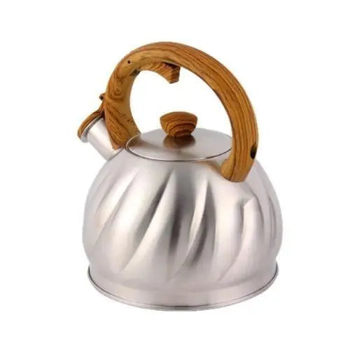 Whistling kettle with lid and handle on stovetop burner