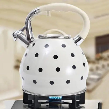 Vintage white polka dot teapot on gas stove