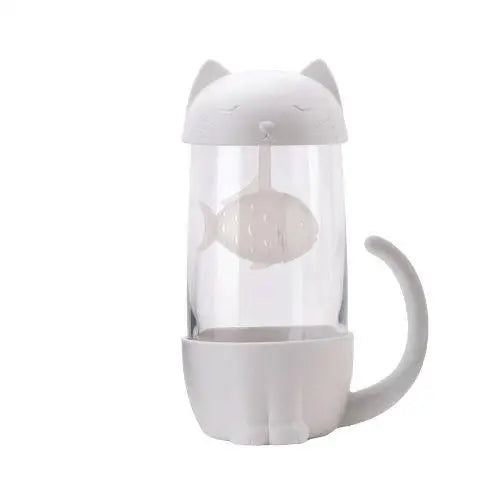 Clear glass tea cup showing white cat and fish infuser design