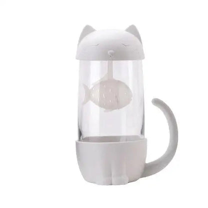 Clear glass tea cup showing white cat and fish infuser design