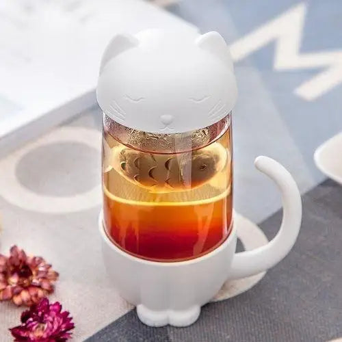 Gray fish infuser inside clear glass cat tea cup close-up
