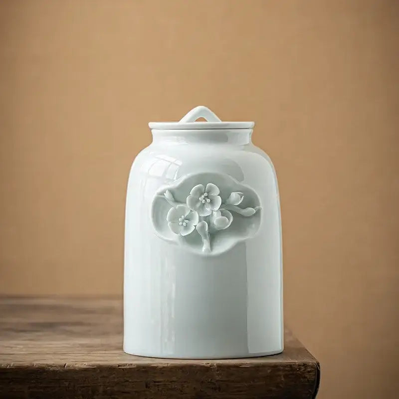 White ceramic tea canister with airtight lid on kitchen counter