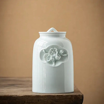 White ceramic tea canister with airtight lid on kitchen counter