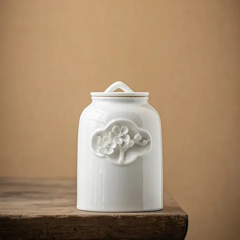 White ceramic tea canister next to stacked tea bags, 660 ml