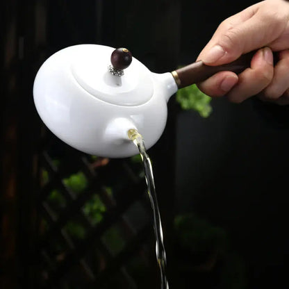 White ceramic teapot for one on a table
