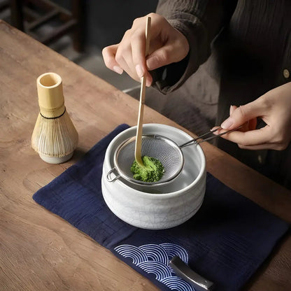White Japanese chawan matcha bowl in use with tea