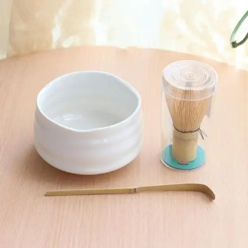 White chawan tea bowl on wooden table with tea
