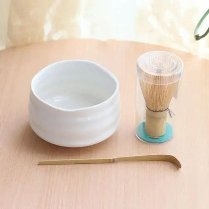 White chawan tea bowl on wooden table with tea