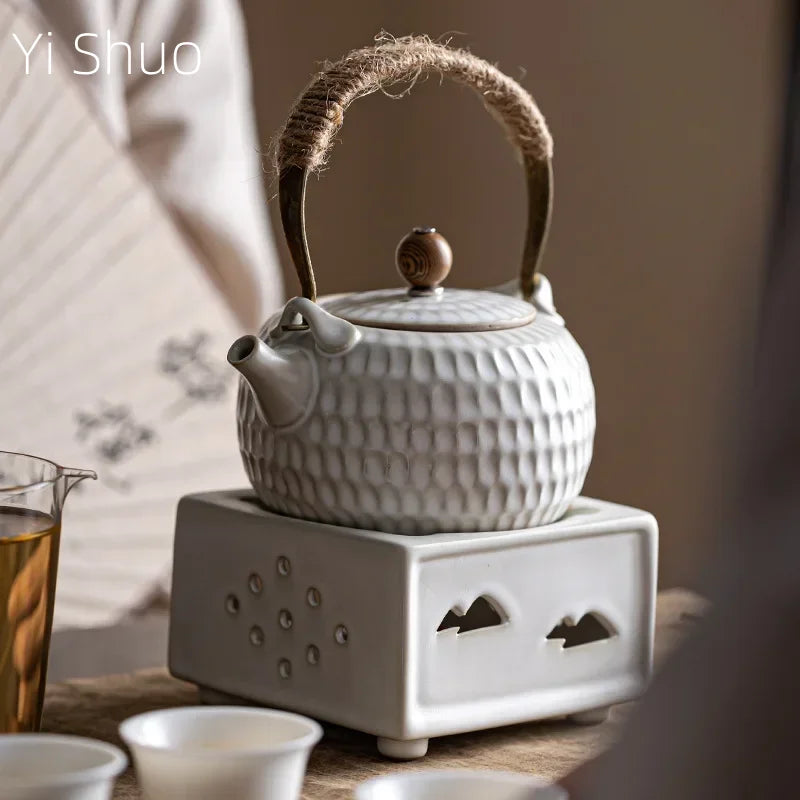 Close-up of white Chinese ceramic teapot spout showing glaze texture and pour detail