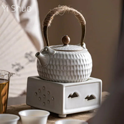 Close-up of white Chinese ceramic teapot spout showing glaze texture and pour detail