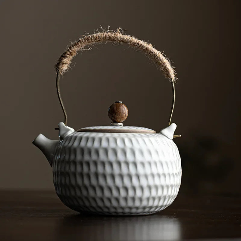 White Chinese ceramic teapot with natural wooden knob lid detail