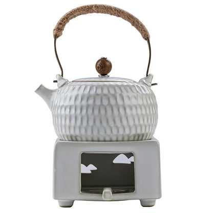 White Chinese ceramic teapot on tea tray with matching cups, table setting