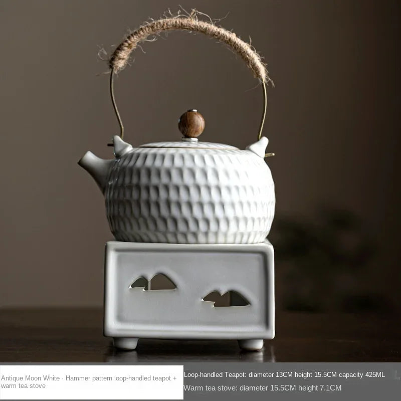Hand gripping braided rope handle of white Chinese ceramic teapot, heat-safe hold