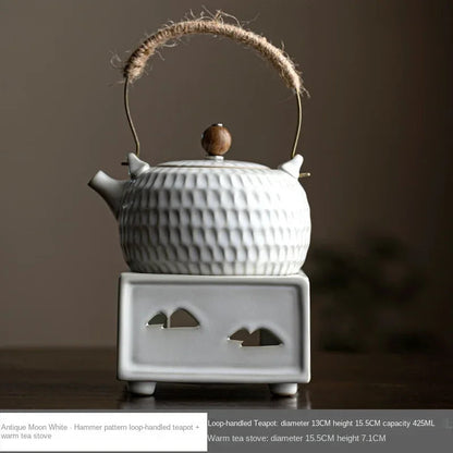 Hand gripping braided rope handle of white Chinese ceramic teapot, heat-safe hold