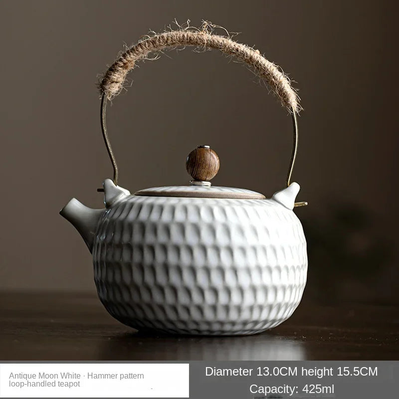 White ceramic teapot with textured glaze surface in natural daylight
