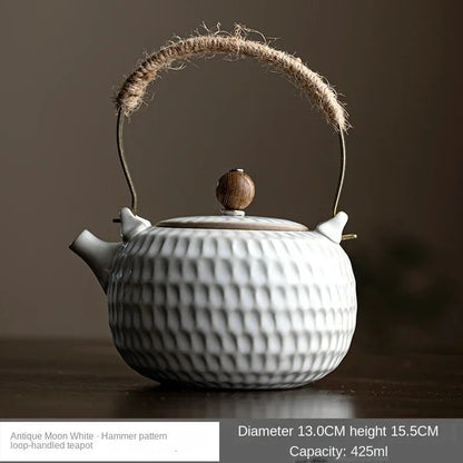 White ceramic teapot with textured glaze surface in natural daylight