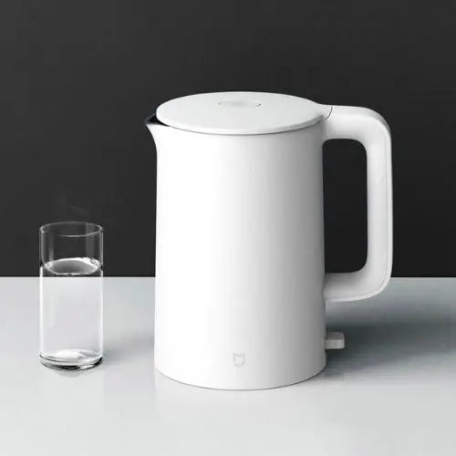 White electric kettle front view on kitchen counter