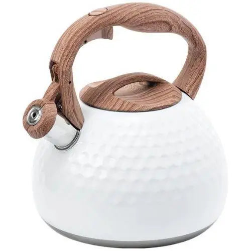 White modern whistling kettle sitting on a gas stove burner