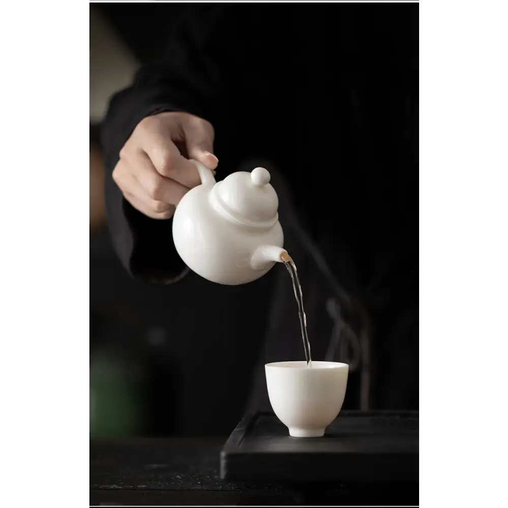 White teapot with built-in strainer