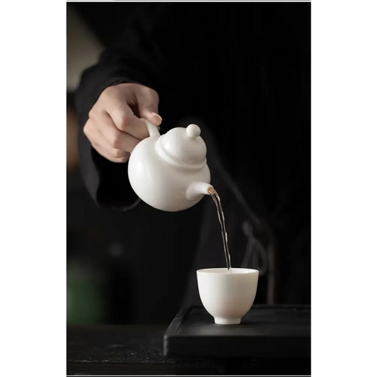 White teapot with built-in strainer