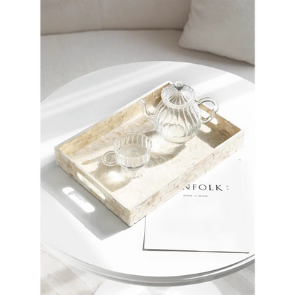 White tea tray holding teacup and cookies
