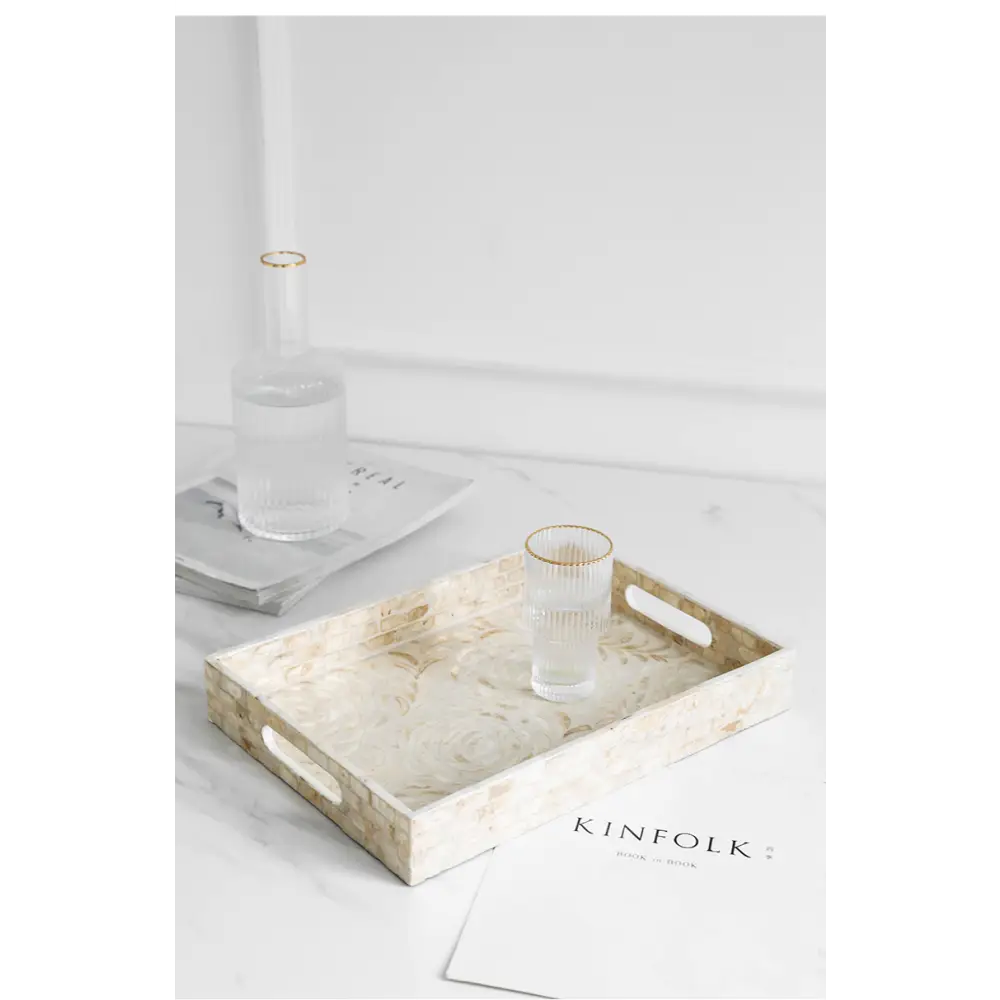 White tea tray with shell design on sideboard