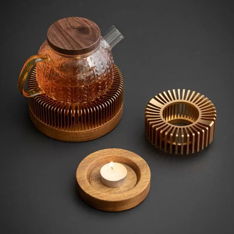 Candle-powered teapot warmer with tea light lit underneath ceramic teapot
