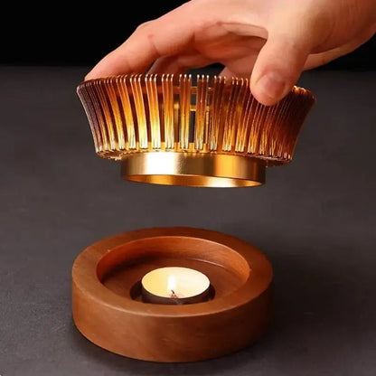 Close-up of gold metal finish and cut-out pattern on wood and metal teapot warmer