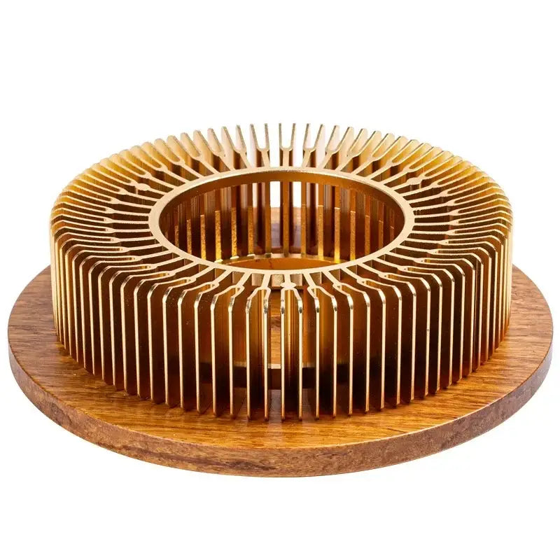 Wood and metal teapot warmer on wooden table beside ceramic tea cup
