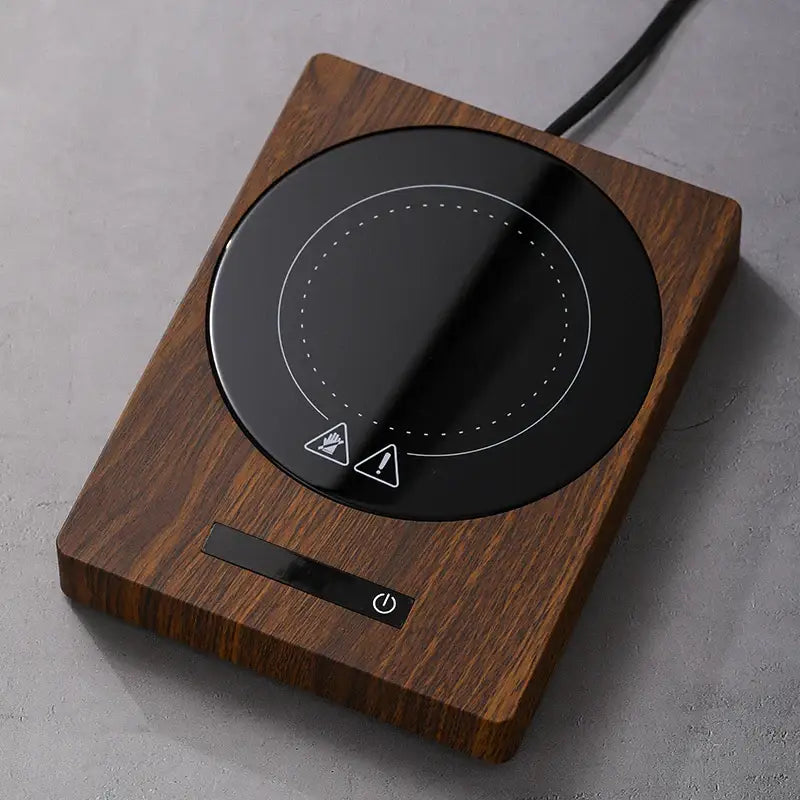 Dark brown wooden mug warmer with a stainless steel mug