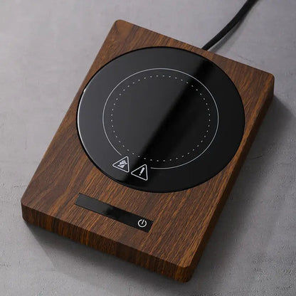 Dark brown wooden mug warmer with a stainless steel mug