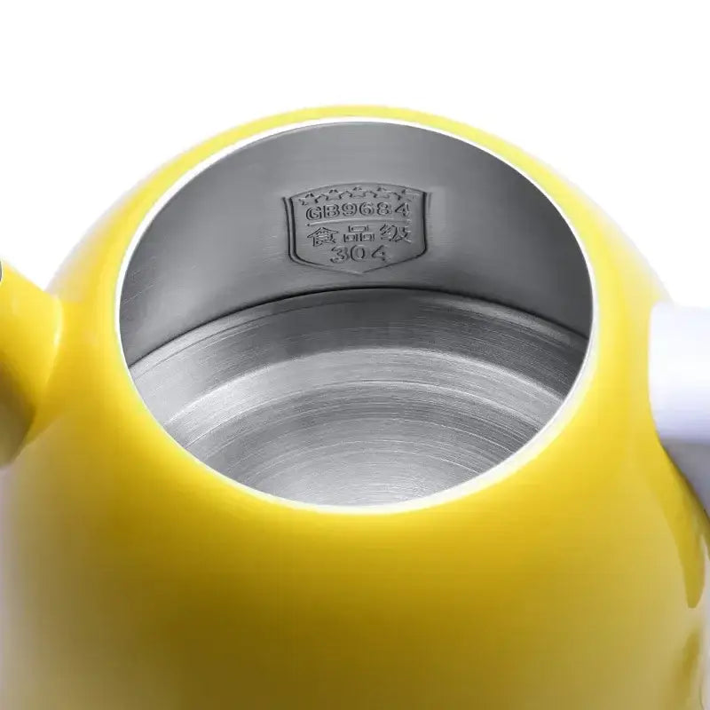 Yellow stainless steel kettle 1L pouring hot water into a ceramic tea cup