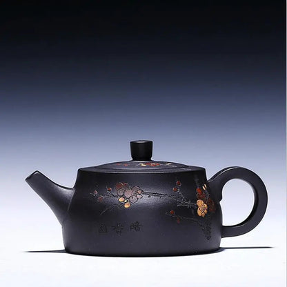 Black Yixing clay teapot with hand-carved flower motif, matte zisha finish