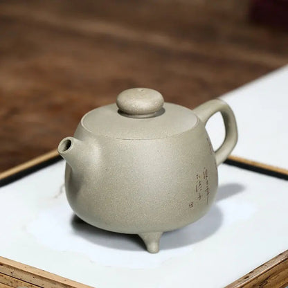 Handmade Yixing teapot side angle showing lid, spout, and handle detail