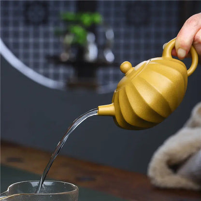 Yixing clay teapot used for gongfu cha brewing, small cups and loose leaf oolong