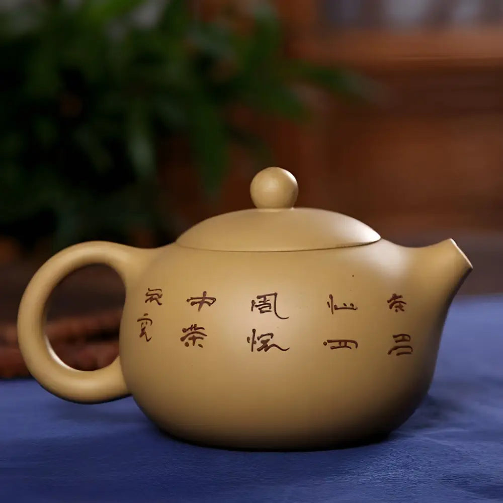 Beige Chinese zisha teapot displayed on wooden tea tray