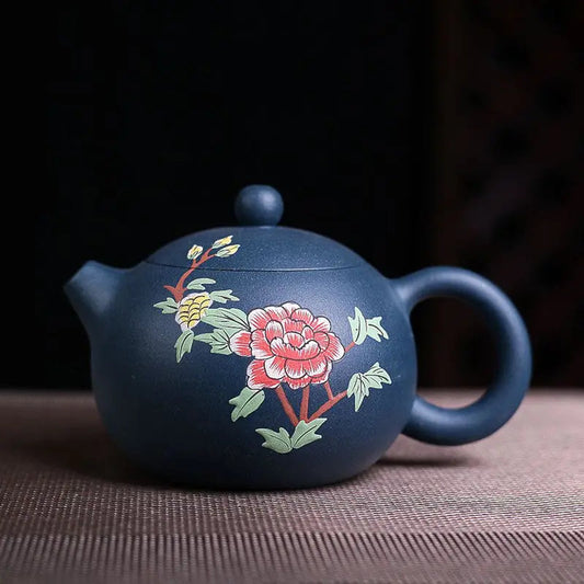 Yixing zisha clay teapot with hand-painted blue flower, front view