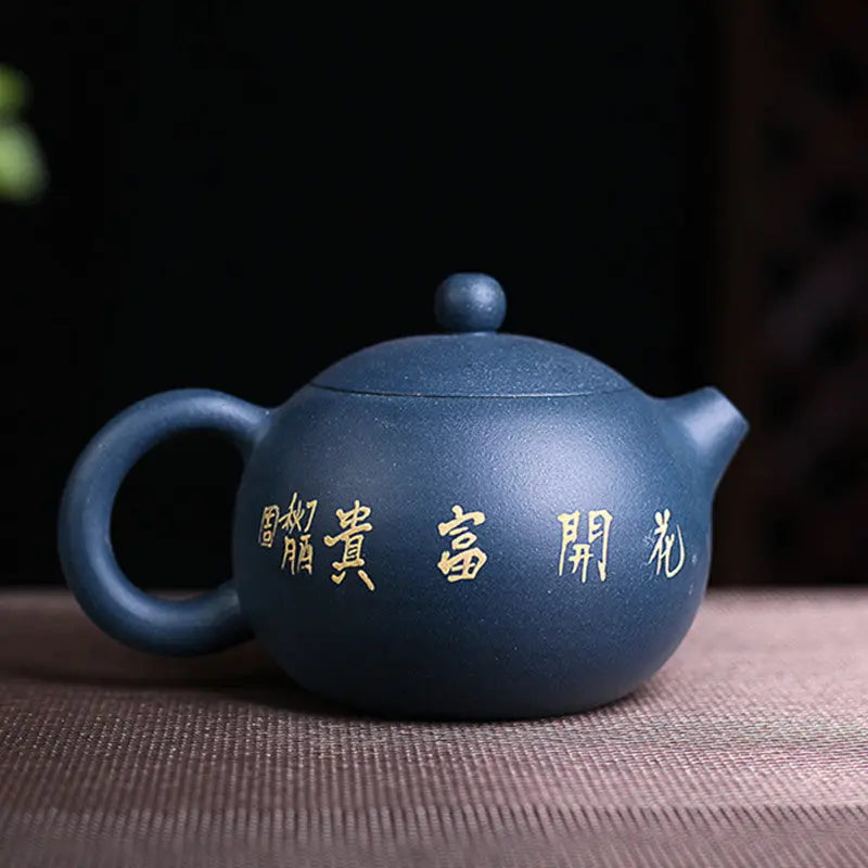 Yixing clay teapot blue cobalt flower motif, side angle showing spout