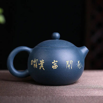 Yixing clay teapot blue cobalt flower motif, side angle showing spout