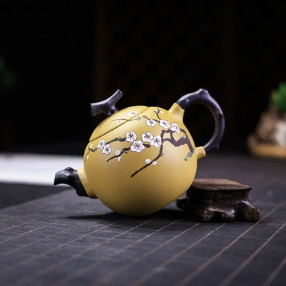 Close-up of hand-carved cherry blossom design on unglazed Yixing zisha teapot