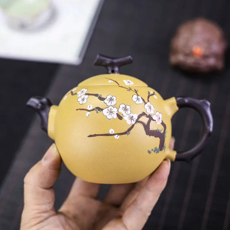 Pouring tea from 250ml Yixing zisha teapot with cherry blossom carving
