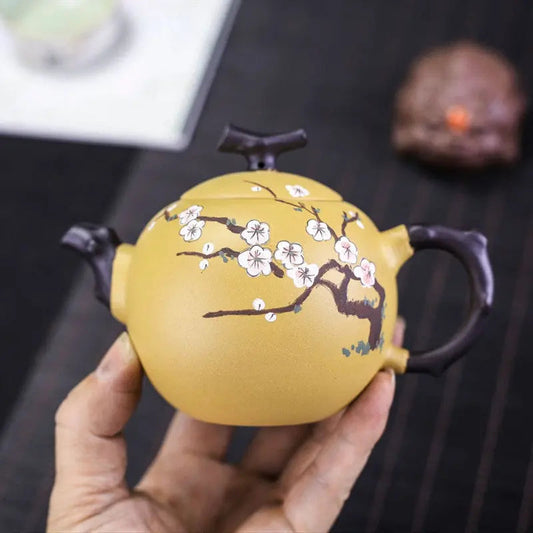 Pouring tea from 250ml Yixing zisha teapot with cherry blossom carving