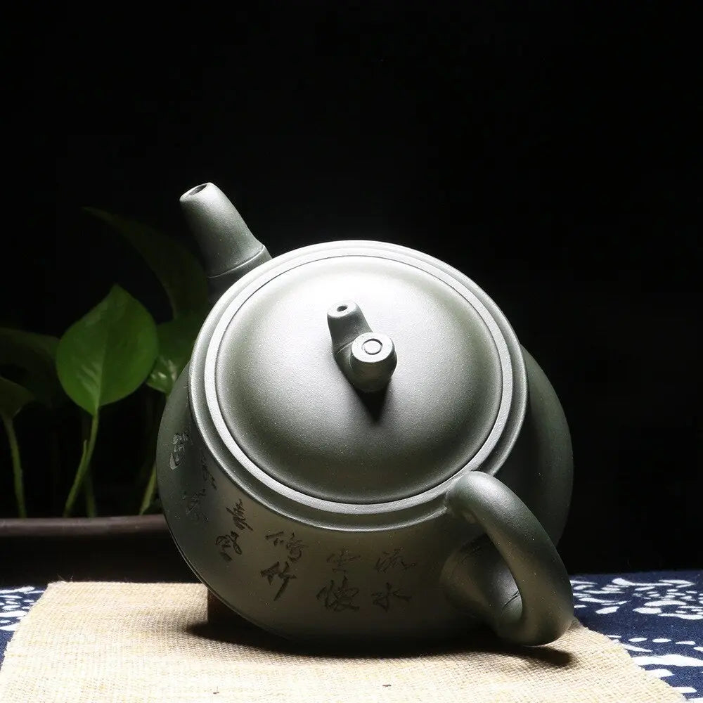 Close-up of hand-brushed Chinese calligraphy on Yixing clay teapot surface