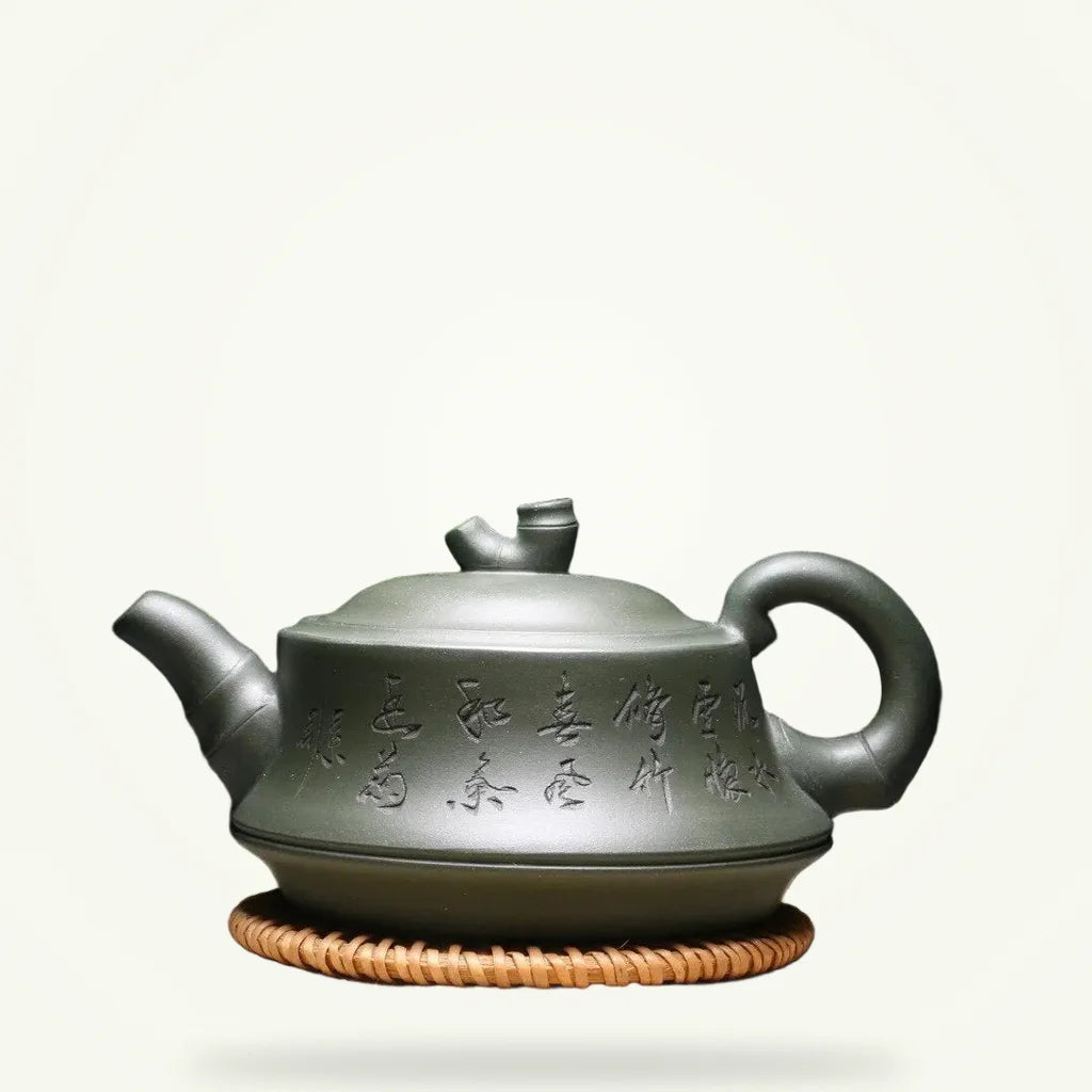 Yixing clay teapot with Chinese calligraphy 240ml on plain background, front view