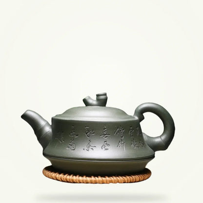 Yixing clay teapot with Chinese calligraphy 240ml on plain background, front view