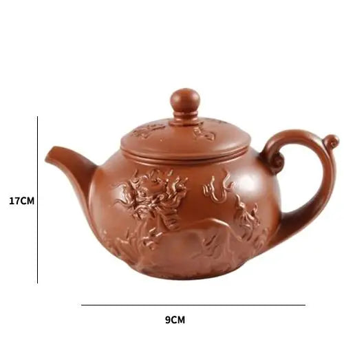 Red Yixing clay teapot showing size