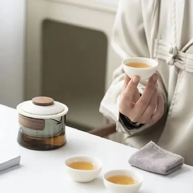 Zen tea set with steam rising from freshly brewed cup of green tea
